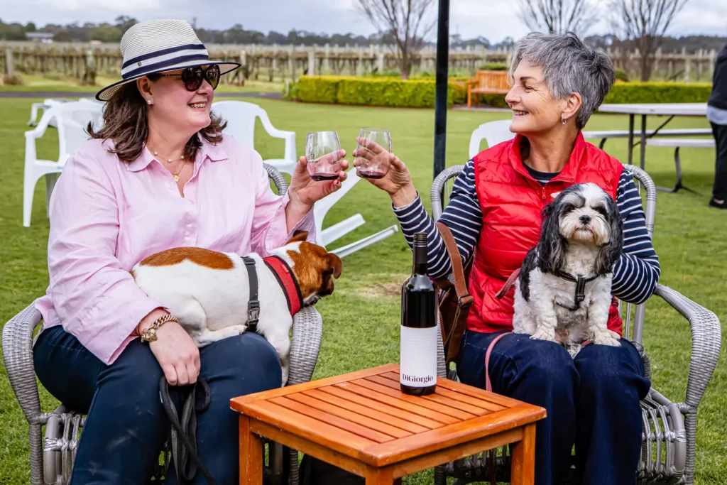 ladies drink wine with dogs in coonawarra